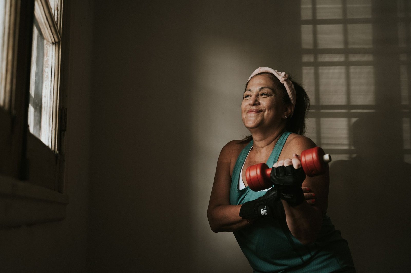 Mujer haciendo ejercicio con mancuernas en casa